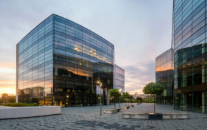 Modern glass buildings at sunset.